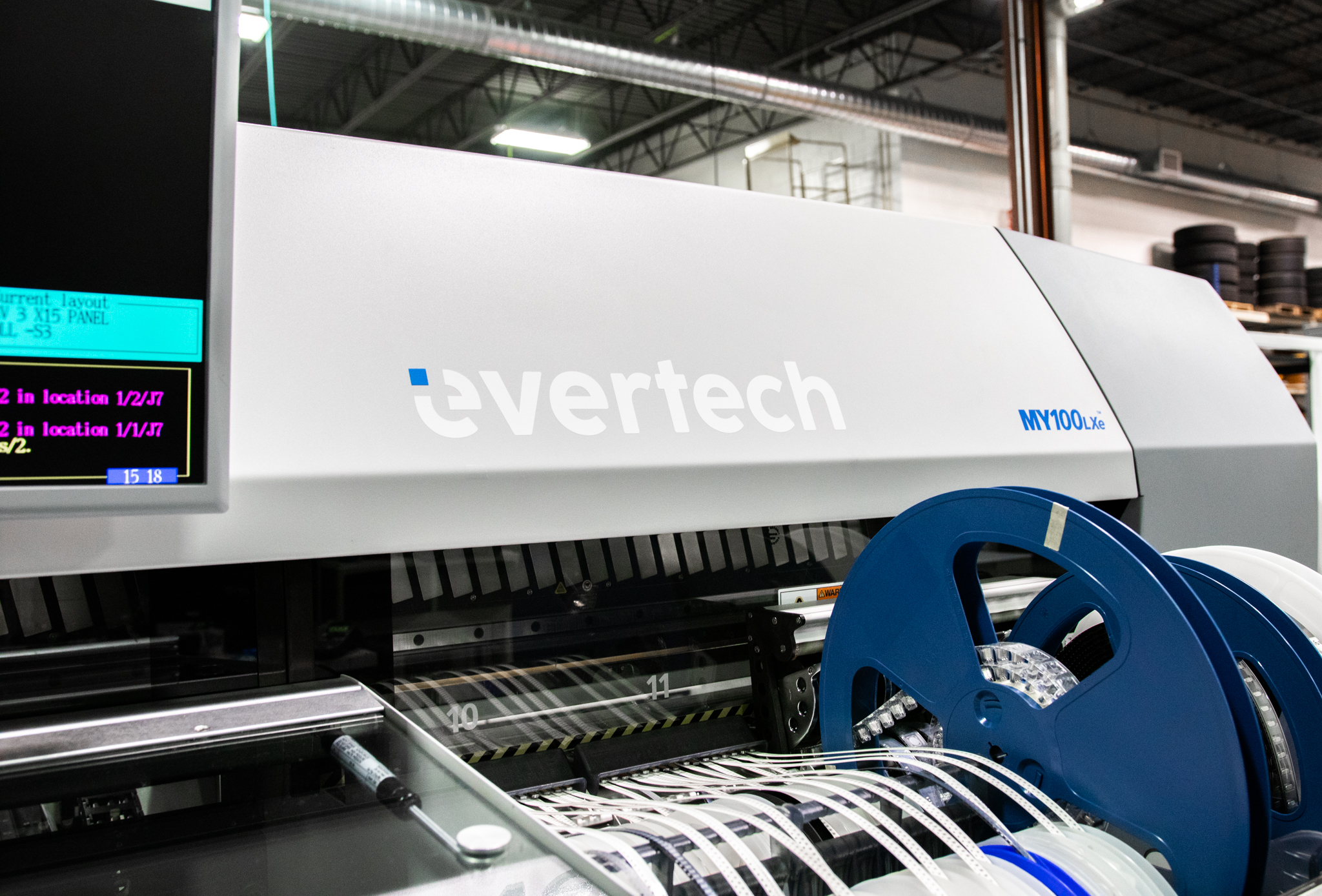 EverTech MY100LXe SMT pick-and-place machine loaded with component reels running a PCB assembly job